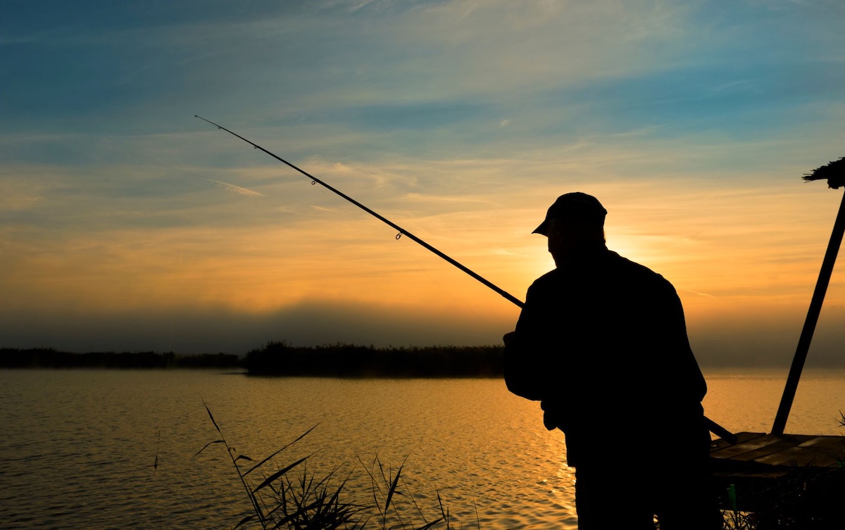 Man fishing at sunrise