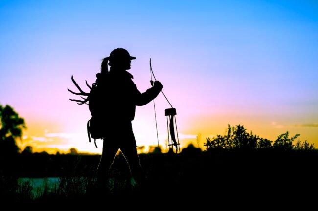 Woman bow hunting for white-tailed deer