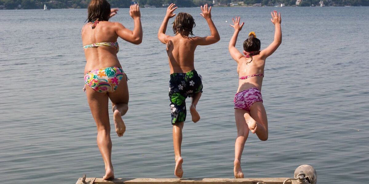 Family jumping off dock