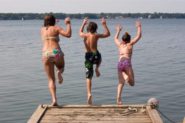 Family jumping off dock