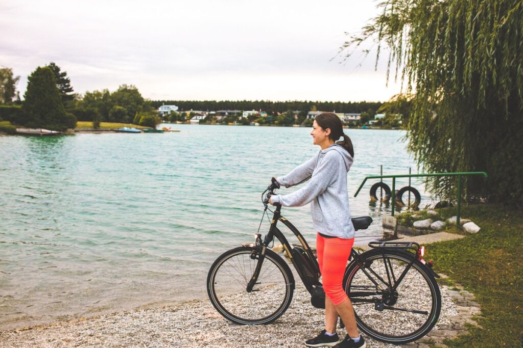 Woman with electric bike at the lake