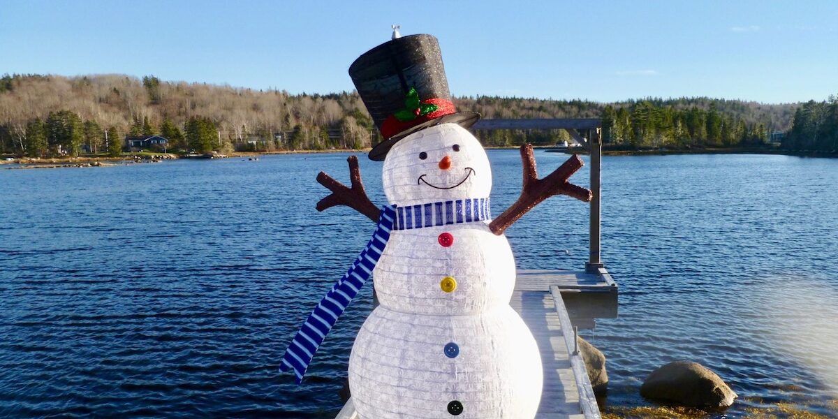 Snowman on a lake dock