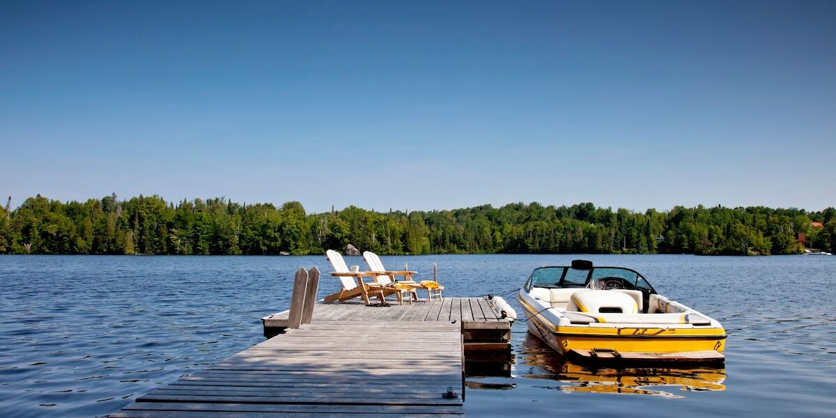 Untitled design – 1 Yellow ski boat and a dock