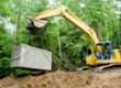 Septic system being put in place by backhoe